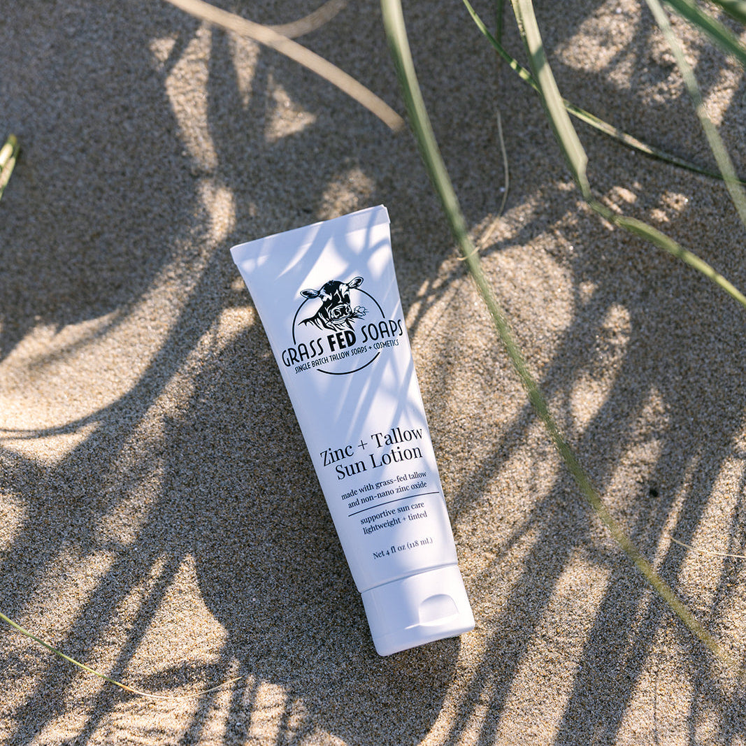 Grass Fed Soaps Zinc and Tallow Sun Lotion in sand
